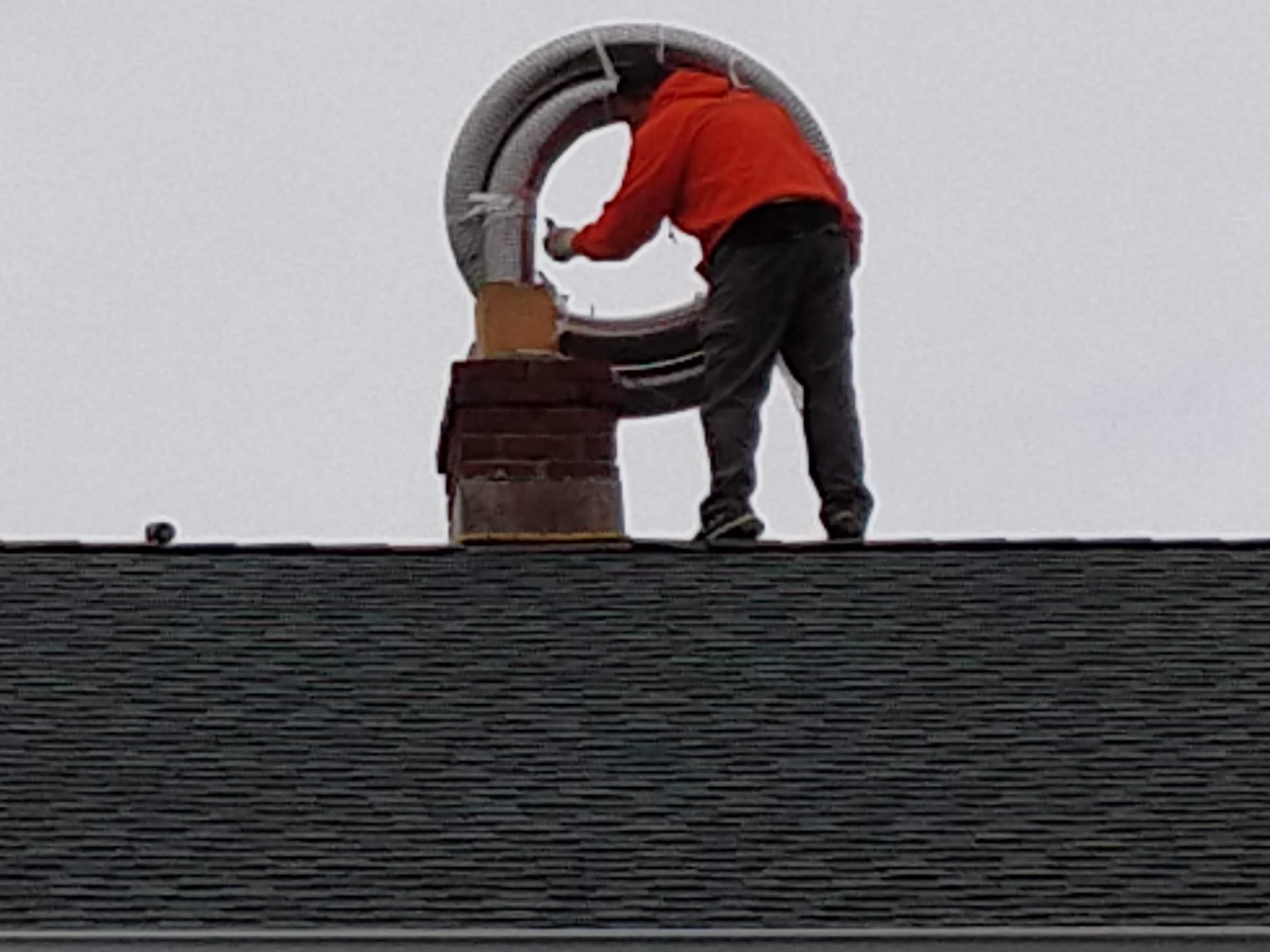 Flexible stainless chimney liner being installed in Merrick, New York